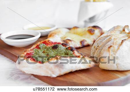 Fresh pizza bread with dipping sauces on chopping board View Large Photo Image Stock Image - Fresh pizza bread with dipping sauces on chopping board. Fotosearch