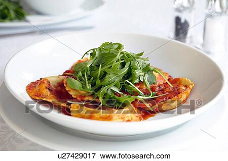 Stock Photo - Fresh ravioli with rocket in bowl. Fotosearch