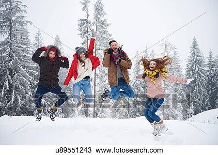 Friends jumping in snow View Large Photo Image Stock Image - Friends jumping in snow. Fotosearch