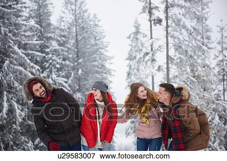 Stock Photo - Friends laughing in snow. Fotosearch