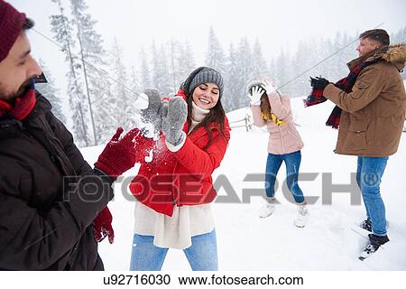 Stock Image - Friends playing in snow. Fotosearch