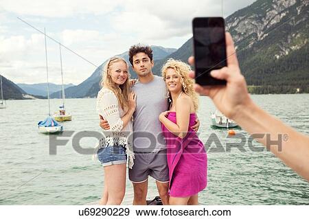 Friends posing for photograph, Innsbruck, Tirol, Austria, Europe View Large Photo Image Stock Photo - Friends posing for photograph, Innsbruck, Tirol, Austria, Europe. Fotosearch
