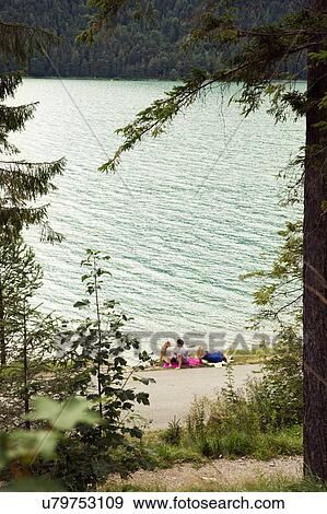 Stock Photo - Friends relaxing by Achensee, Innsbruck, Tirol, Austria, Europe. Fotosearch