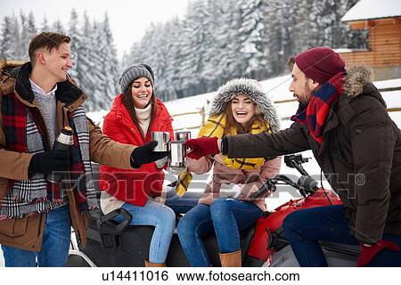 Stock Photograph - Friends toasting outdoors in winter. Fotosearch