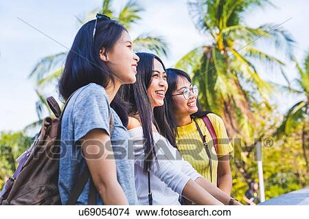 Friends walking and sightseeing in park, Bangkok, Thailand View Large Photo Image Picture - Friends walking and sightseeing in park, Bangkok, Thailand. Fotosearch