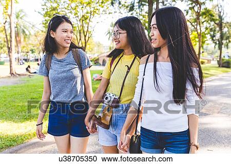 Friends walking and sightseeing in park, Bangkok, Thailand View Large Photo Image Stock Image - Friends walking and sightseeing in park, Bangkok, Thailand. Fotosearch