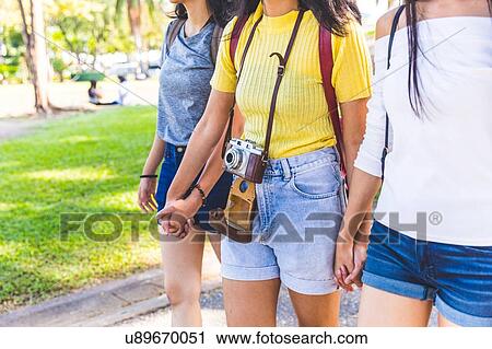 Friends walking and sightseeing in park, Bangkok, Thailand View Large Photo Image Stock Image - Friends walking and sightseeing in park, Bangkok, Thailand. Fotosearch