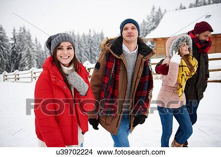 Picture - Friends walking in snow. Fotosearch