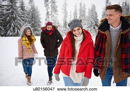Friends walking in snow View Large Photo Image Stock Photo - Friends walking in snow. Fotosearch