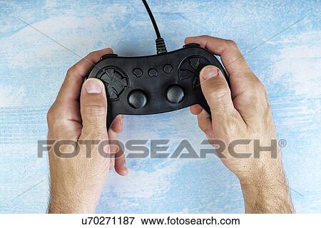 Stock Photo - Gamer using video game controller, top view.. Fotosearch