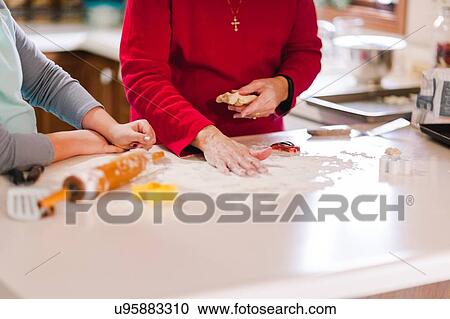 Girl and grandmother preparing flour on kitchen bench, mid section View Large Photo Image Stock Image - Girl and grandmother preparing flour on kitchen bench, mid section. Fotosearch