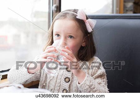 Girl drinking glass of water View Large Photo Image Stock Image - Girl drinking glass of water. Fotosearch