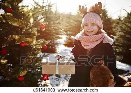 Girl in christmas tree forest wearing antlers, portrait View Large Photo Image Stock Image - Girl in christmas tree forest wearing antlers, portrait. Fotosearch