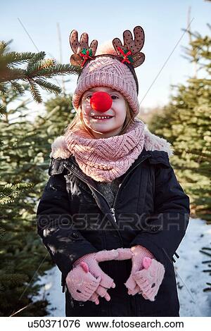 Girl in christmas tree forest with red nose, portrait View Large Photo Image Stock Photograph - Girl in christmas tree forest with red nose, portrait. Fotosearch