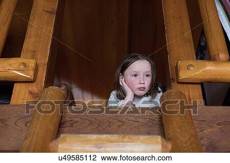 Girl lying on loft floor feeling bored View Large Photo Image Stock Image - Girl lying on loft floor feeling bored. Fotosearch