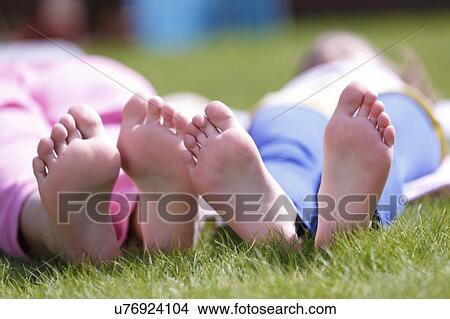 Girls' bare feet on grass. View Large Photo Image Picture - Girls' bare feet on grass.. Fotosearch