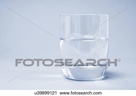 Glass of water on a blue background. View Large Photo Image Stock Image - Glass of water on a blue background.. Fotosearch