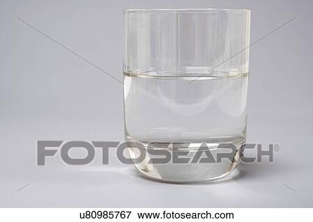Glass of water on a grey background. View Large Photo Image Stock Photo - Glass of water on a grey background.. Fotosearch