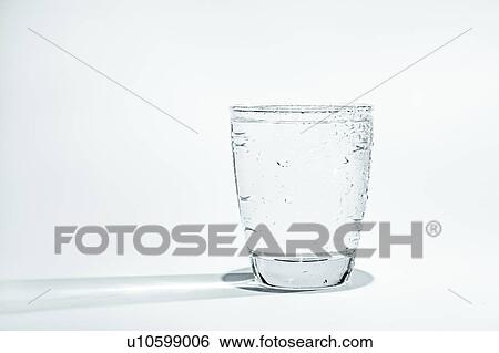 Glass of water with condensation on a blue background. View Large Photo Image Stock Photograph - Glass of water with condensation on a blue background.. Fotosearch