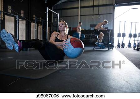 Stock Photograph - Group of people exercising in gymnasium. Fotosearch