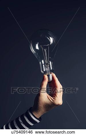 Hand with light bulb. View Large Photo Image Stock Photograph - Hand with light bulb.. Fotosearch