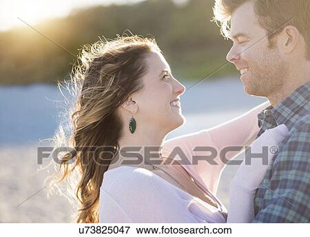 Stock Photo - Happy couple in beach, face to face. Fotosearch