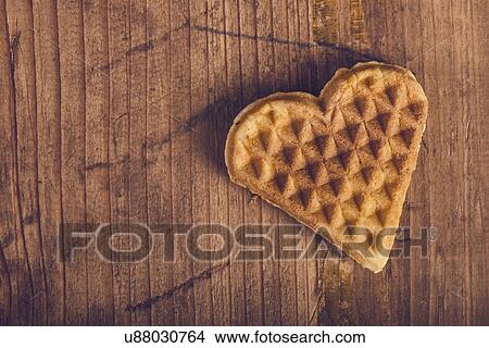 Heart shaped homemade waffle on wooden desk. View Large Photo Image Picture - Heart shaped homemade waffle on wooden desk.. Fotosearch
