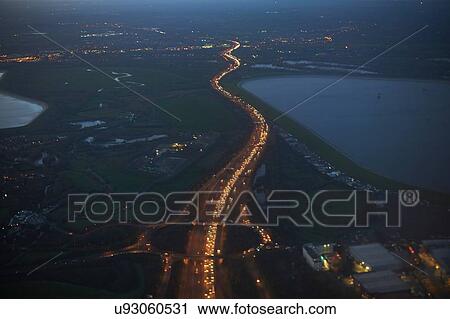 Stock Image - High angle view of Heathrow airport and M25 illuminated at night, London, United Kingdom, Europe. Fotosearch
