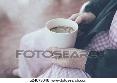 Stock Photograph - Hospital patient holding cup and drinking coffee.. Fotosearch