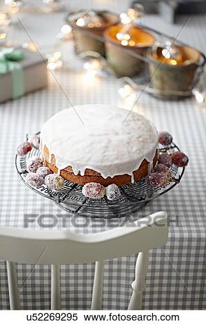 Iced cake on table with decorative lights View Large Photo Image Stock Photography - Iced cake on table with decorative lights. Fotosearch