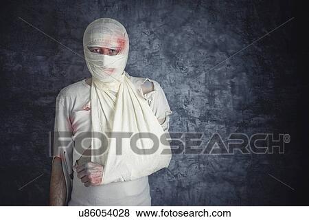 Stock Photo - Injured man with head bandages.. Fotosearch