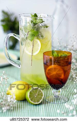 Jug and glass of lemon and lime cordial, with fresh fruit and ice, close-up View Large Photo Image Stock Image - Jug and glass of lemon and lime cordial, with fresh fruit and ice, close-up. Fotosearch