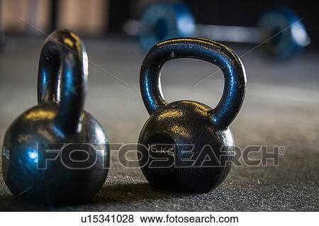 Kettlebells on gymnasium floor, close-up View Large Photo Image Stock Photo - Kettlebells on gymnasium floor, close-up. Fotosearch