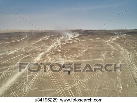 Landscape view of off road vehicles crossing dusty desert, Ica, Peru View Large Photo Image Stock Photo - Landscape view of off road vehicles crossing dusty desert, Ica, Peru. Fotosearch