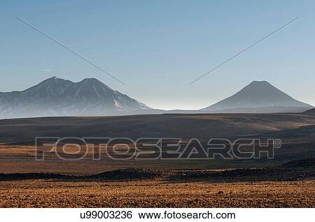 Stock Photograph - Landscape with mountains at dawn from road to Paso Sico, Atacama Desert, Chile. Fotosearch