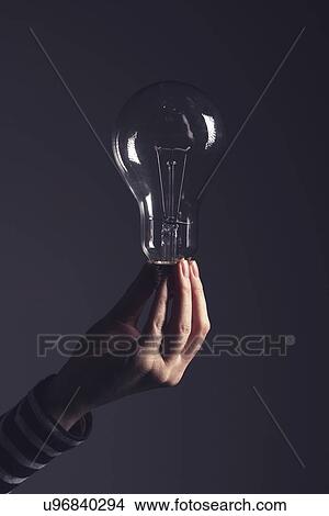 Picture - Light bulb in female hand.. Fotosearch