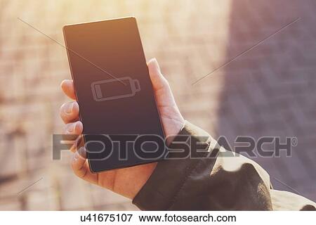 Stock Photo - Low battery warning notification on mobile phone screen.. Fotosearch