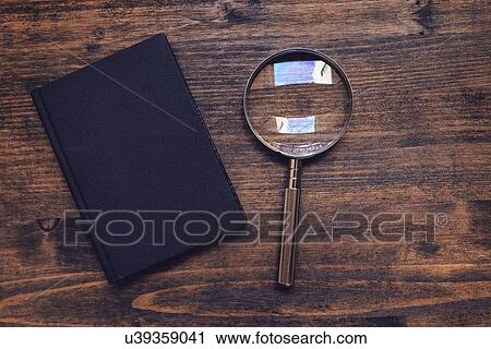 Magnifying glass and notebook on wooden desk, top view. View Large Photo Image Stock Image - Magnifying glass and notebook on wooden desk, top view.. Fotosearch