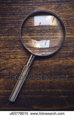 Magnifying glass on wooden desk, top view. View Large Photo Image Stock Photography - Magnifying glass on wooden desk, top view.. Fotosearch