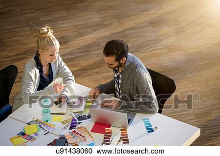 Male and female designer discussing colour swatches on design studio table View Large Photo Image Stock Image - Male and female designer discussing colour swatches on design studio table. Fotosearch
