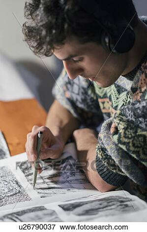 Male artist drawing in sketchbook in artists studio View Large Photo Image Stock Photo - Male artist drawing in sketchbook in artists studio. Fotosearch