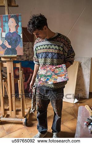 Male artist holding palette in artists studio View Large Photo Image Stock Image - Male artist holding palette in artists studio. Fotosearch