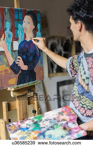 Male artist painting canvas on easel in artists studio View Large Photo Image Stock Photo - Male artist painting canvas on easel in artists studio. Fotosearch
