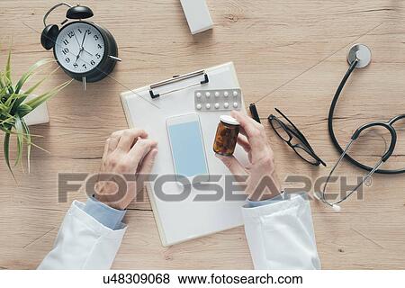 Male doctor holding pills. View Large Photo Image Stock Photo - Male doctor holding pills.. Fotosearch