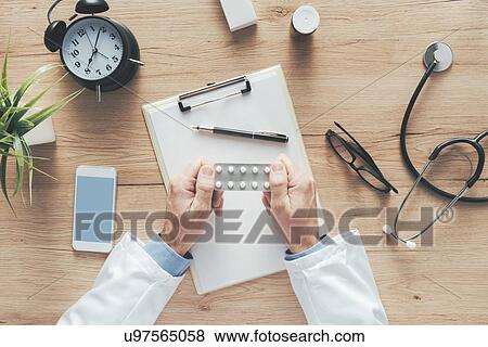 Male doctor holding tablets. View Large Photo Image Stock Photo - Male doctor holding tablets.. Fotosearch