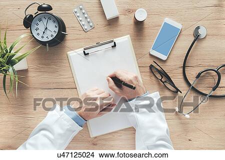 Male doctor writing notes. View Large Photo Image Picture - Male doctor writing notes.. Fotosearch