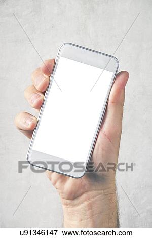 Stock Photo - Male hand holding mobile phone with blank mock up screen.. Fotosearch