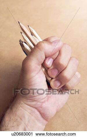 Stock Image - Male illustrator and sketch artist with handful of pencils.. Fotosearch