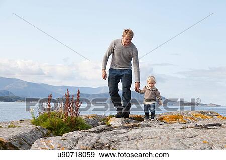 Man and son strolling by fjord, Aure, More og Romsdal, Norway View Large Photo Image Stock Photo - Man and son strolling by fjord, Aure, More og Romsdal, Norway. Fotosearch