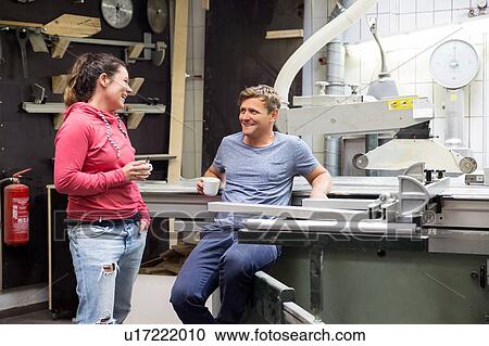 Man and woman in workshop, having conversation View Large Photo Image Stock Image - Man and woman in workshop, having conversation. Fotosearch
